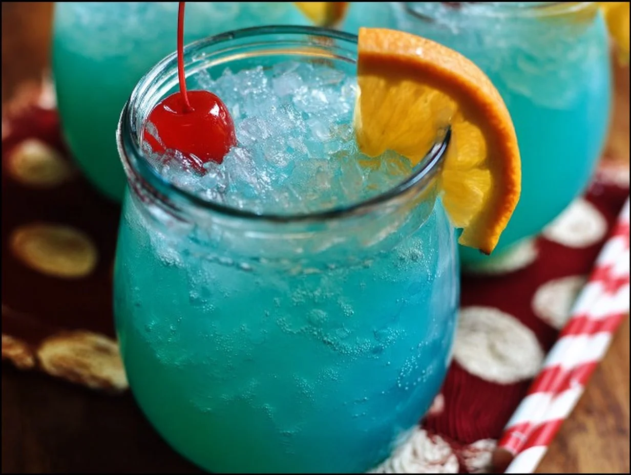 A vibrant glass of Blue Hawaiian Punch served at a festive gathering.